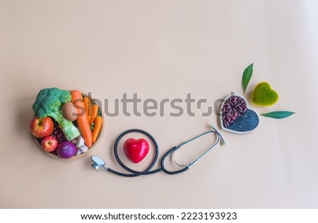 Organic  heathy  food  in  wooden  bowls , medical  stethoscope , red hearts  shape  on  pastel  background  for  the  health  concept .Top  view  and  copy  space  for  use . Royalty-Free Stock Photo #2223193923