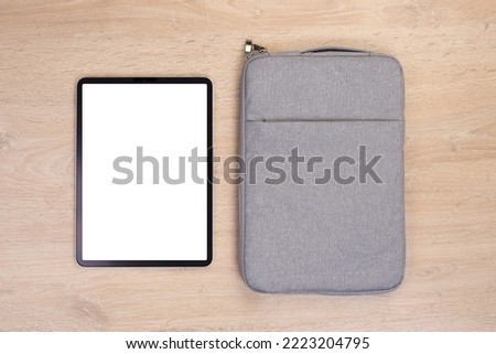 Mockup tablet with bag on wooden background