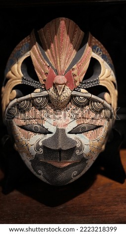 Javanese Batik Mask made of mahogany wood on a white background. This wood mask personifies a Javanese lord or Gusti.