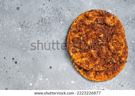Turkish pizza lahmacun on kitchen table. Gray background. Top view. Copy space.