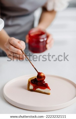 Serving delicious cherry cheesecake. Close-up of a cake. High quality photo Royalty-Free Stock Photo #2223232111