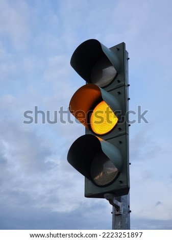 A yellow light that glows at the traffic light.