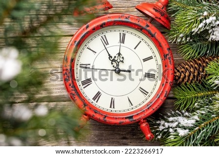 New Year alarm clock and fir tree. Christmas greeting card