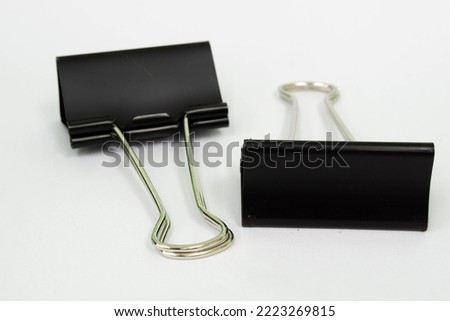 Black paper clip on white backgroud