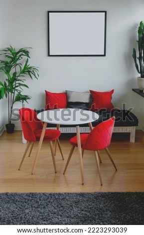 A modern apartment with red pillows and chairs