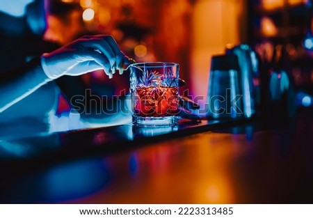 woman bartender hand making cocktail in nightclub Royalty-Free Stock Photo #2223313485