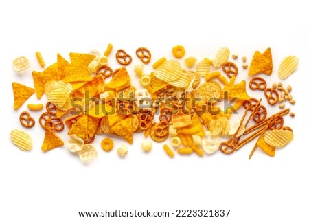 Salty snacks texture on a white background. Party food mix. Potato and tortilla chips, crackers and other appetizers, overhead flat lay shot Royalty-Free Stock Photo #2223321837