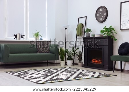 Stylish living room interior with decorative fireplace and sofa