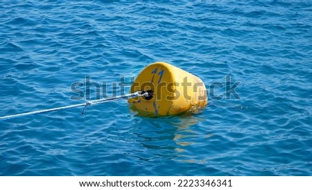 summer, sea, in transparent bluish water floats orange buoy. High quality photo