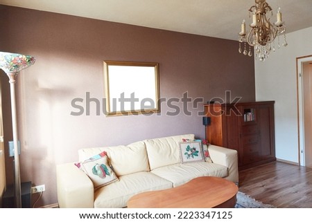 Old-fashioned living room with picture frame mock-up template on wall