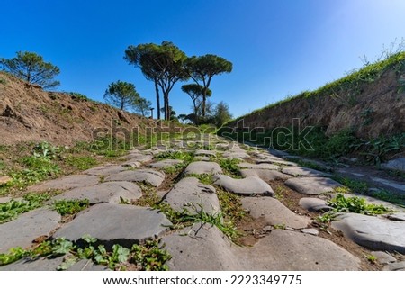 Ancient Appia road inside the Parco degli Acquedotti (Aqueducts Park) in Rome, Italy. The park is named after the old aqueducts that run through it. Royalty-Free Stock Photo #2223349775