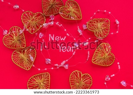 On a red background, the inscription New Year and Christmas decorations. Christmas toys.