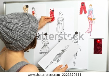 The tailor designs the dresses. The fashion designer develops sketches of women's fashionable clothes. Seamstress workplace.