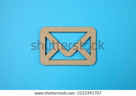 Blank cardboard envelope isolated on blue background with free copyspace for your creativity ideas text. Mail concept.