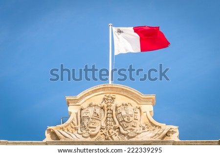 Maltese white and red flag against a blue sky - Top of prime minister building parliament in La Valletta capital of Malta mediterranean island