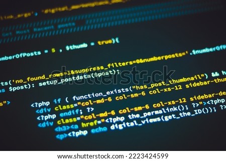 Programming code screen with colourful tags in browser view on dark background