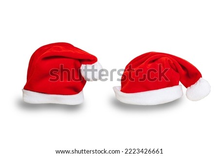 Set of two Santa red hats isolated on white background. Copy space. Suitable for collage and banner making and any other Christmas and New Year design