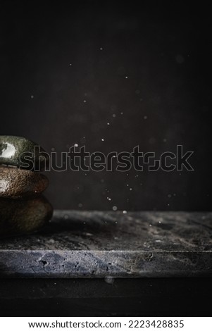Beautiful black stand or podium, scene with black stone and black background. Black background with place for the product. Dark background