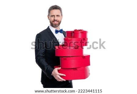 happy tuxedo man hold valentines day box. man in tuxedo holding gift for valentines day.