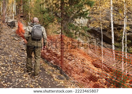Portrait of an elderly man. A trip to the old mica mines in the Ural Mountains. An elderly tourist explores old abandoned caves