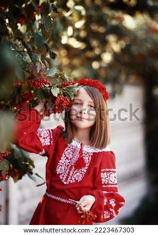               Portrait of a beautiful young Ukrainian woman (girl) in nature. Ukraine, freedom, ethnic national costume.  Retro photo
 in hand viburnum             