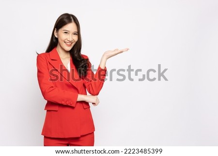 Happy Asian businesswoman presenting or showing open hand palm with copy space for product isolated over white background