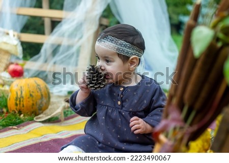 the little child playing in the park with fruits, little girl in the autumn park