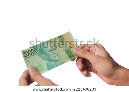man's hand showing twenty thousand rupiah isolated on white background