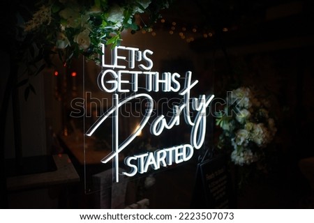 Neon sign let's get this party started Royalty-Free Stock Photo #2223507073