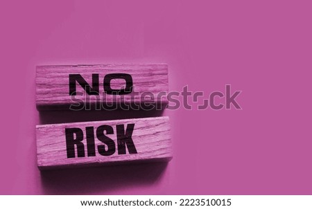 No Risk words on wooden blocks on yellow background. Risk management concept.