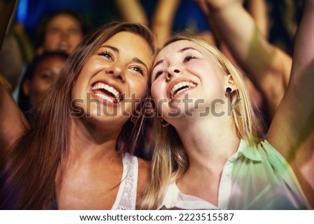 Having the time of their lives. Young girls in an audience enjoying their favourite bands performance. Royalty-Free Stock Photo #2223515587