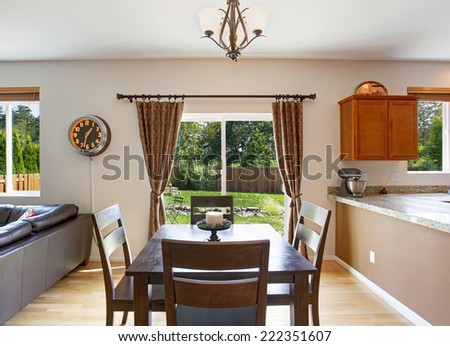 Dining area with brown wooden table set and exit to backyard patio area