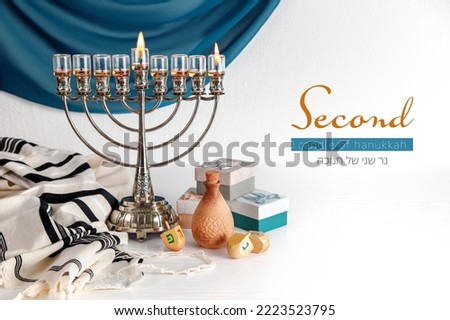 Second candle of Hanukkah (Lettering in English and Hebrew)  with Menorah (traditional candelabra). Jewish religious holiday