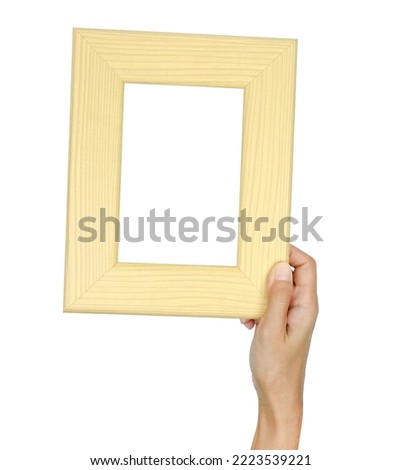 female hand hold a wood photo frame isolated on white background.                      