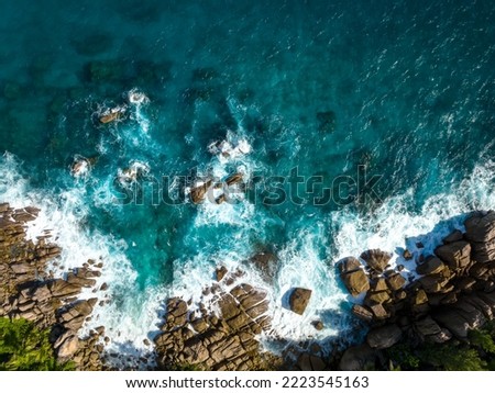 Aerial view Top down seashore. Waves crashing on rock cliff. Beautiful dark sea surface in sunny day summer background Amazing seascape top view seacoast at Intendance Beach, Mahe Seychelles Royalty-Free Stock Photo #2223545163