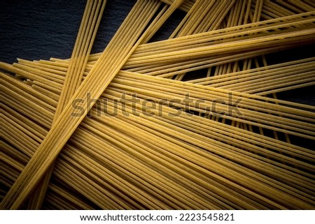 Italian spaghetti on a black slate stone background with space for your text. concept. geometry. food. style