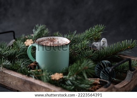 A cup of coffee with Golden Christmas lights on a dark background. New year's sale concept. Greeting card concept. Happy Christmas holliday. Place for your text.