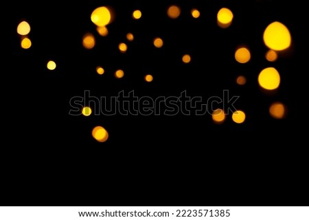 Gold bokeh on dark background. Defocused golden lights. New Year, Christmas background, abstract texture Royalty-Free Stock Photo #2223571385