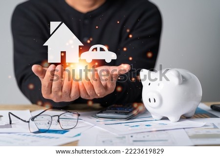 Businessman hand-holding icon with a piggy bank and business document, the concept for saving money, investment, tax, analyzing economic, loan, income or salary planning