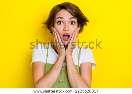 Closeup photo of funny charming woman touching cheeks nervous shocked high prices scared bankruptcy isolated on yellow color background
