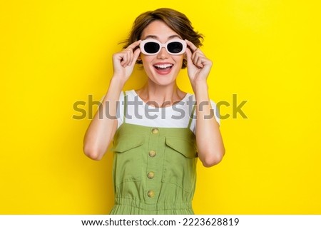 Photo of young hipster girl summertime vacation wear sunglasses rayban excited shocked how cool weekend isolated on yellow color background
