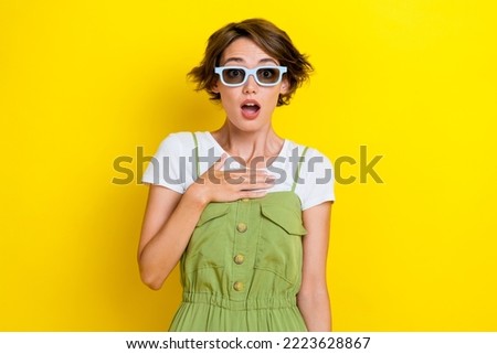 Portrait photo of young funny confused lady wear 3d glasses spectacles unexpected high quality film touch chest isolated on yellow color background