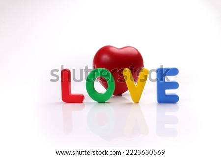 red green blue yellow plastic toy capital font letter alphabet love on white background red hart love shape copy text space concept