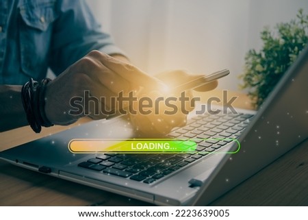 Casual Businessman Touching Mobile Phone or Smart Phone and Yellow Green Loading Bar and Laptop Computer. Searching or Downloading Concept in Vintage Tone