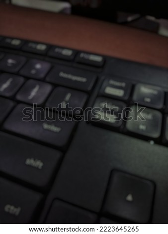 Defocused abstract background of black keyboard, with the words delete, enter, up, down, right, left, shift, ctrl, backspace