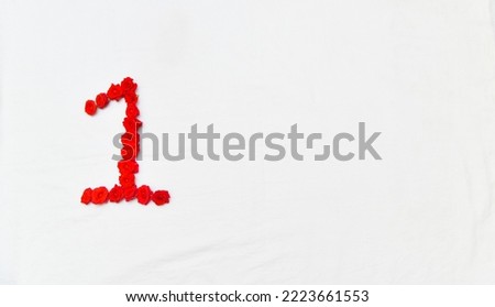 Red rose Flower and petals forming number 1 on white background.