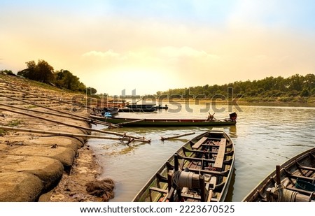 Local fishery, Yasothorn Dam, Phanomphai Dam, fisherman boats floating on dam background, local fishing, Flood gate dam open for agriculture, Boats in the river, local fisherman village Thailand.