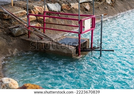 Discharge water from lake with blue water.