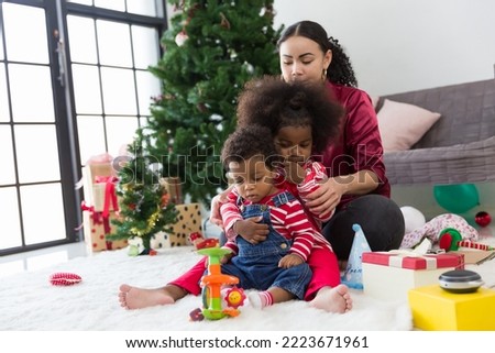 Happy family playing together on Christmas day at home. Merry Christmas and Happy Holidays. Happy family on Christmas