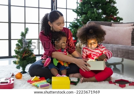 Happy family opening Christmas gift box or presents gift at home. Merry Christmas and Happy Holidays